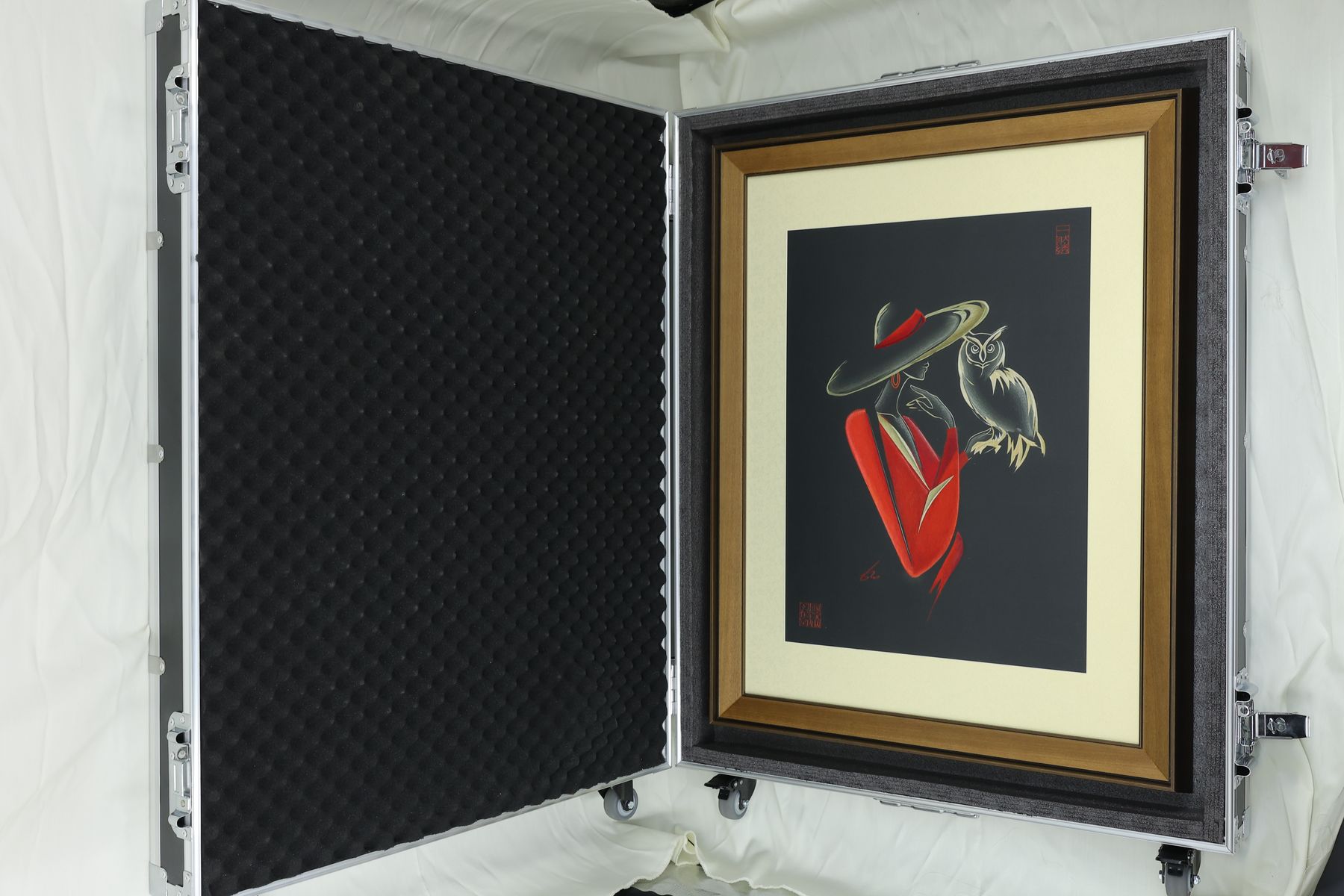Framed Owl Queen resting inside a foam-lined aluminium presentation case.